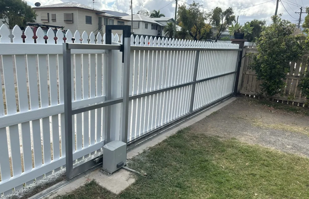 A long timber fence run freshly painted white